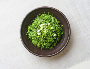 Sticker - Close-up and top angle view of Seasoned Seaside green(Spergularia marina) on a jar and cloth, South Korea
