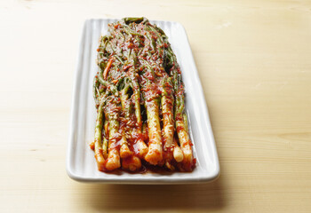 Canvas Print - Close-up of Pagimchi(green onion kimchi) with stems and leaves on rectangular dish, South Korea
