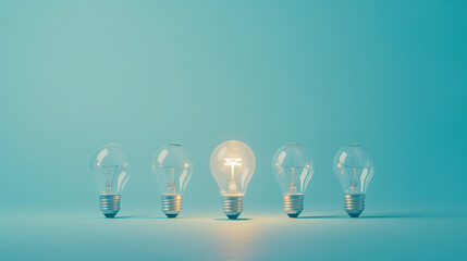 Wall Mural - Row of Light Bulbs with One Glowing on Blue Background Symbolizing Innovation