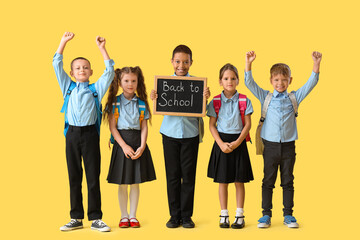 Sticker - Little pupils holding chalkboard with text BACK TO SCHOOL on yellow background