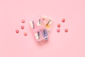 Wall Mural - Plastic container with pills on pink background. Top view