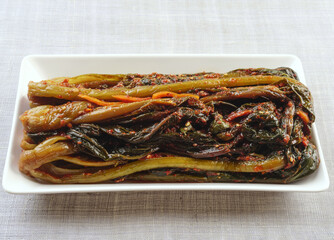 Wall Mural - Close-up of old Mustard Kimchi on a rectangular dish, South Korea
