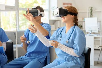 Canvas Print - Young doctors using VR glasses with controllers in clinic