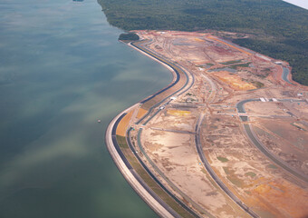 Land reclamation - parts of beaches being transformed into usable land by filling in the sea or ocean in Singapore and Malaysia