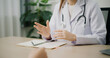 © Johnstocker - Selective focus hands of Asian doctor explains health problem of young female patient in clinic office, Health and medicine consultant, conversation about healthcare