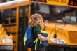 © Volodymyr - Schoolboy getting on the school bus. American School. Back to school. Kid of primary school. Happy children ready to study. Happy little Student.