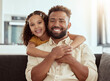 © peopleimages.com - Hugging, sofa and portrait of child with father for love, care and bonding together in home. Smile, connection and girl kid embracing dad for relax in living room on weekend at house in Colombia.