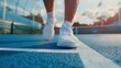 © G.Go - A person is running on a tennis court with a white shoe