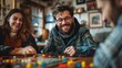 © Tracto - Friends playing a board game showing their close bond and playful affection in a relaxed setting
