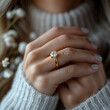 © Hamsyfr - close up photo of a finger woman with a diamond ring on the finger with a minimalist background