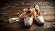 © Wanlop - A shallow focus captures a pair of elegant pointed ballet shoes adorned with satin ribbons on a dark wooden floor.