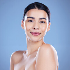 Canvas Print - Woman, happy and portrait in studio for skincare, cosmetics and confidence in beauty. Female person, dermatology and smile on blue background for transformation, aesthetic and spa treatment for glow