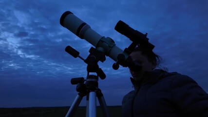 Wall Mural - amateur astronomer looking at the evening cloudy skies, expecting to observe planets, stars, moon an
