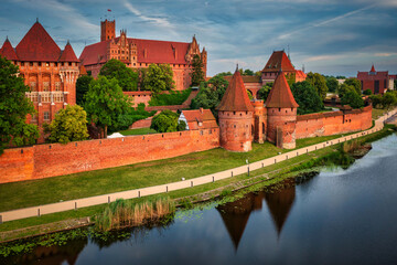 Wall Mural - Castle of theTeutonic Order in Malbork by the Nogat river at sunset.