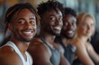 © Vladan - Four young adults enjoying a workout session, showcasing friendship and fitness in a vibrant gym environment. Perfect for health and lifestyle themes.