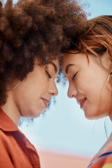 Poster - Couple, lesbian and forehead touch in outdoor, bonding and blue sky for security. People, lgbtq and hug for romance on holiday or together for profile date, support partner and embrace on vacation