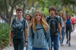 © darshika - Full length portrait of confident students walking in a row on college campus