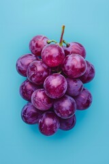 Wall Mural - A bunch of grapes are shown on a blue background