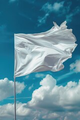 A white flag is blowing in the wind on a cloudy day