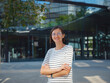 © Seleznov_Molchanova - Asian woman over background of modern urban architecture in Vienna.