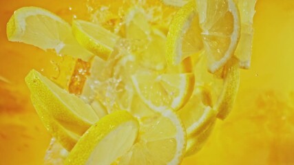 Canvas Print - Super Slow Motion of Falling Lemon Slices into Water, Colored Background. Filmed on High Speed Cinema Camera, 1000 fps. Camera Tracking the Target.