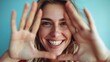 © Ketanoff - Portrait of cheerful smiling young woman raising her hand and putting it in front of her face.