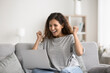 © fizkes - Happy woman sits on couch at home with laptop, check email, get great fantastic news, screams with joy, make gesture of winner, celebrate success, relish moment of lottery win, receive on-line prize