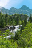 Morskie Oko, or Eye of the Sea. View of the Czarnostawianska Siklawa waterfall. Summer landscape in the Tatras