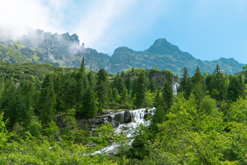 Wall Mural - Morskie Oko, or Eye of the Sea. View of the Czarnostawianska Siklawa waterfall. Summer landscape in the Tatras