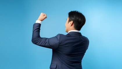 Wall Mural - Businessman raising his fist to show resolve.