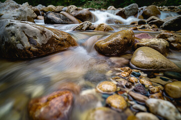 Sticker - Pristine stream in mountain flowing over rocks