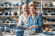 © Olga Che - Couple in pottery workshop. Ceramic art business. Senior man and young woman in craft clay work shop. Owner and artist. Mature person hobby. Active Retired people making pot in blue handicraft store