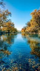 Wall Mural - Serene Autumn River with Vibrant Foliage and Tranquil Waters under Clear Blue Sky