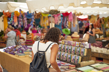 Wall Mural - People looking at goods at the Uzès market, one of the most beautiful in France