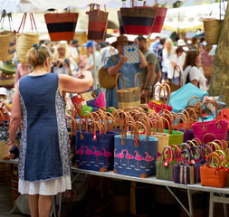 Wall Mural - People looking at goods at the Uzès market, one of the most beautiful in France