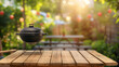 © watz - Black grill on wooden table in a backyard setting. ..