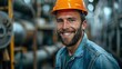 © frank29052515 - Confident Male Engineer in Hardhat Smiling Against Factory Background