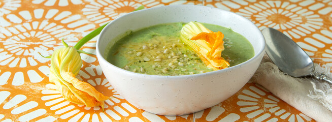 Wall Mural - bowl of creamy zucchini soup on the table