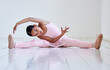 © CineLens2024/peopleimages.com - Ballet, portrait and stretching with girl on floor of studio for start of dance class, recital or rehearsal. Getting ready, split and warm up with African child dancer preparing for performance