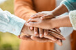 © DavisShared/peopleimages.com - Unity, people and pile of hands with bonding for support, care and trust in outdoor. Community, team building and partnership with commitment for love, peace and solidarity together with hope