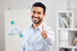 © Clayton D/peopleimages.com - Portrait, business and man with thumbs up in office for agreement, motivation or thank you. Sign, financial broker and Asian employee with hand gesture for confidence, support or investment success