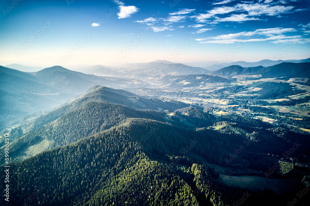 Aerial view of densely forested mountains stretching into distance ...
