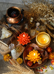 Sticker - amulets, flowers, candles, witchcraft items, witch cauldron, wheat ears, crystals on table. magic Esoteric Ritual for Lammas, Lughnasadh. energy healing spiritual practice. top view