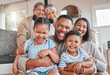 © DavisShared/peopleimages.com - Portrait, smile and big family in home with kids, grandma and grandfather bonding in living room. Face, mother and father hug children, happy grandparents and generations laughing together for love