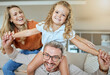 © peopleimages.com - Happy, family and airplane lounge parents and bonding with daughter on couch, portrait and fun. Home, girl and mom in living room, woman and man with child, playful and games for care and love
