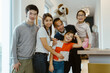 © Maskot - Portrait of happy family posing together at home
