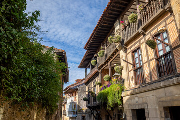 Sticker - Beautiful houses of the medieval old town of Santillana del Mar, Cantabria, Spain with wooden beams and balconies with flowers