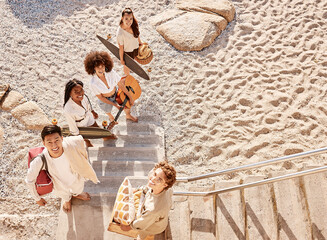 Wall Mural - Fun, picnic and portrait of friends on beach together with guitar, skateboard and basket from above. Diversity, relax and group of happy gen z people on ocean holiday with smile, social or solidarity