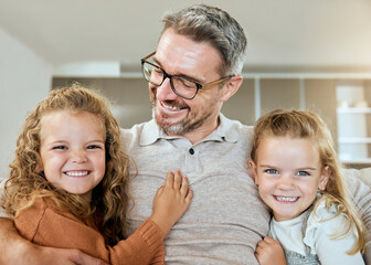 Wall Mural - Portrait, girls and dad in lounge, smile and bonding with twins with hug in house, love and happy. Living room, kids and father with embrace for care, childhood and children with parent in apartment