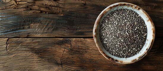 Leinwandbilder - Chia seeds in a bowl displayed on a wooden surface with a blank area for additional content copy space image